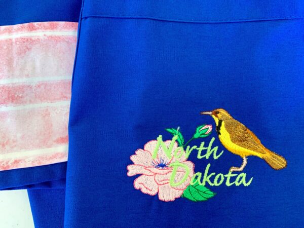 Product image of North Dakota State Flower and Bird Apron