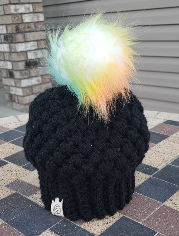 Product image of Black baby hat with colored poof ball 6-12 month size