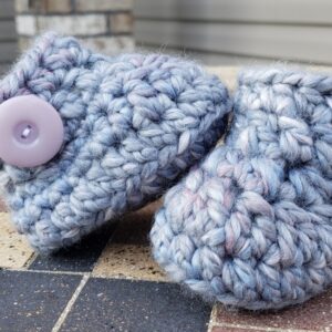 Product image of Grey baby booties with flecks of pink, purple, and blue and light lilac buttons 6-12 months old