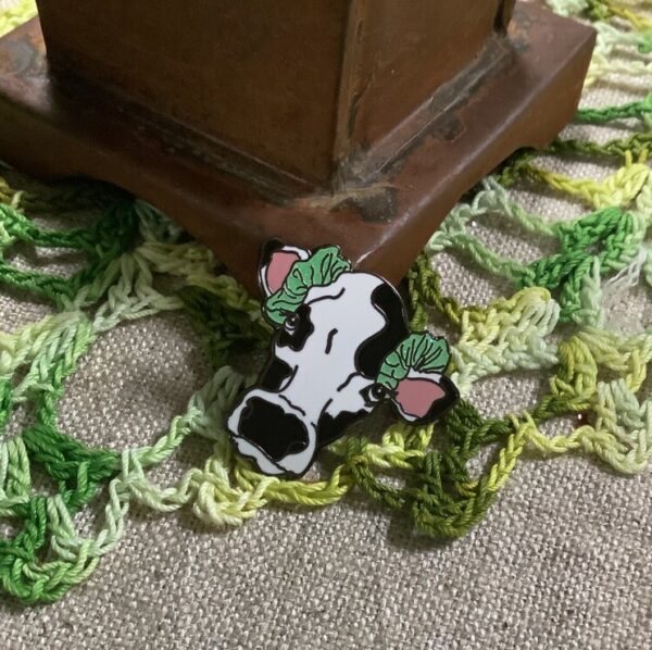 Product image of Handcrafted Enamel Pin – Cow Wearing Hair Scrunchies